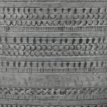Close-up of the Johnsen Handcrafted Metal Coffee Table's metallic surface, featuring horizontal bands with repeating circular and linear engraved patterns for a textured, reflective finish.