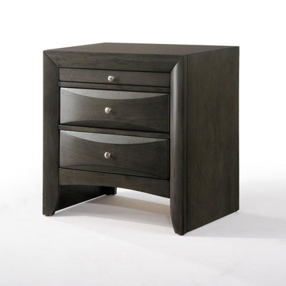 The Ireland - Elegant Design Nightstand features a dark wood finish with three drawers, each equipped with metallic knobs. The slightly curved drawer fronts add elegance, and it stands on four short legs, all captured against a white background.