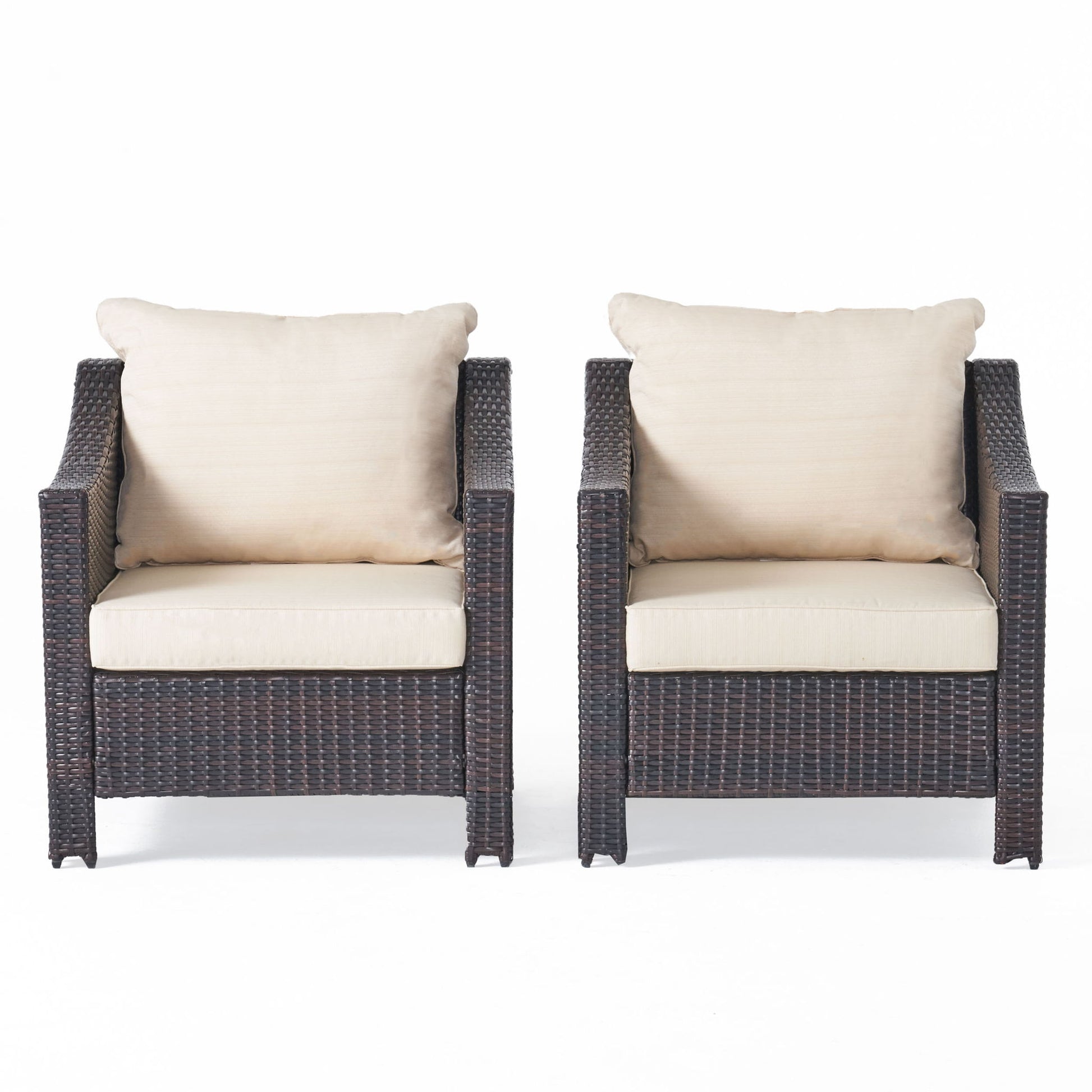 Two Antibes armchairs with water-resistant cream cushions and dark brown wicker frames sit side by side against a plain white background.