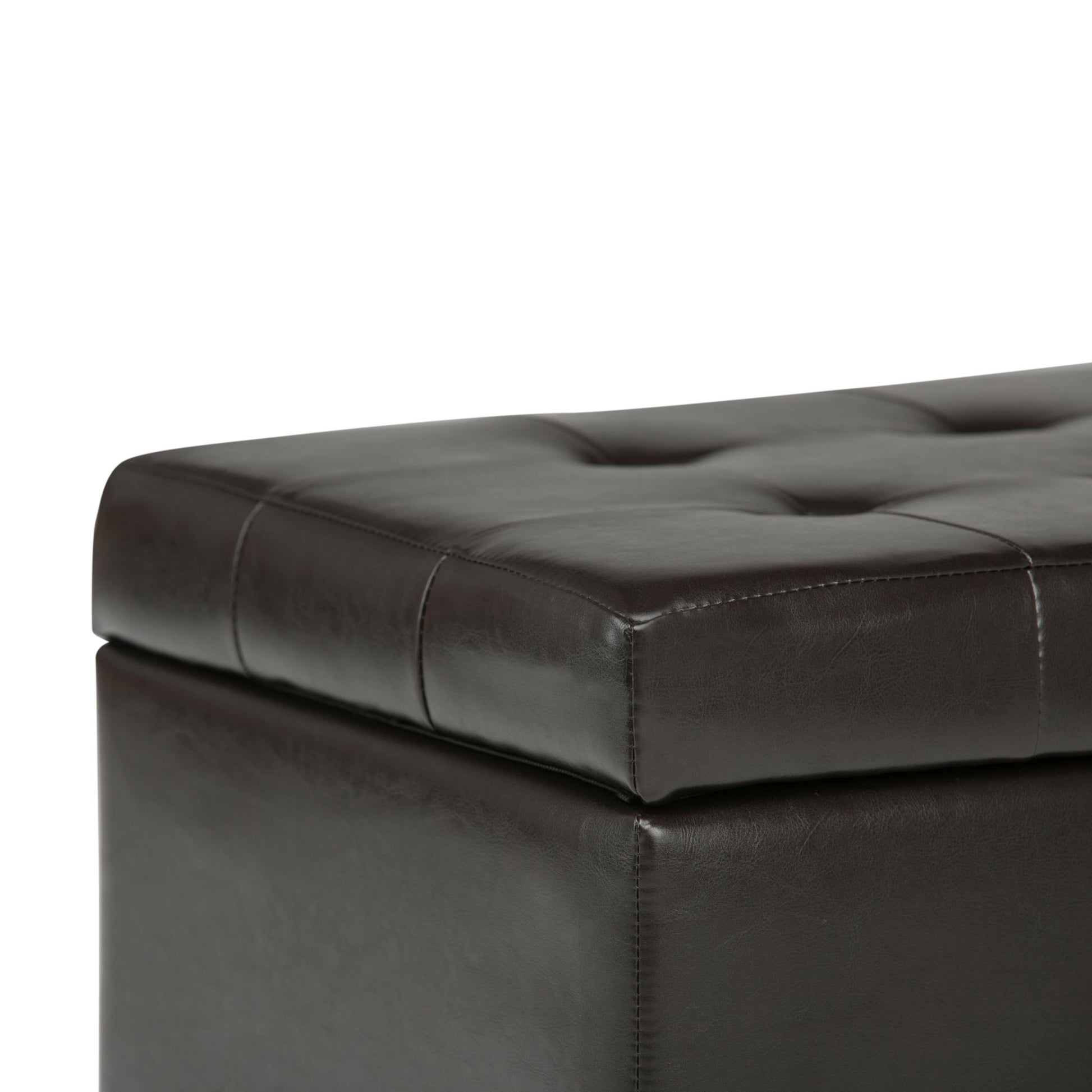 A close-up of the Cosmopolitan - Upholstered Storage Ottoman in dark brown leather, featuring tufted detailing, visible stitching, and a cushioned top.