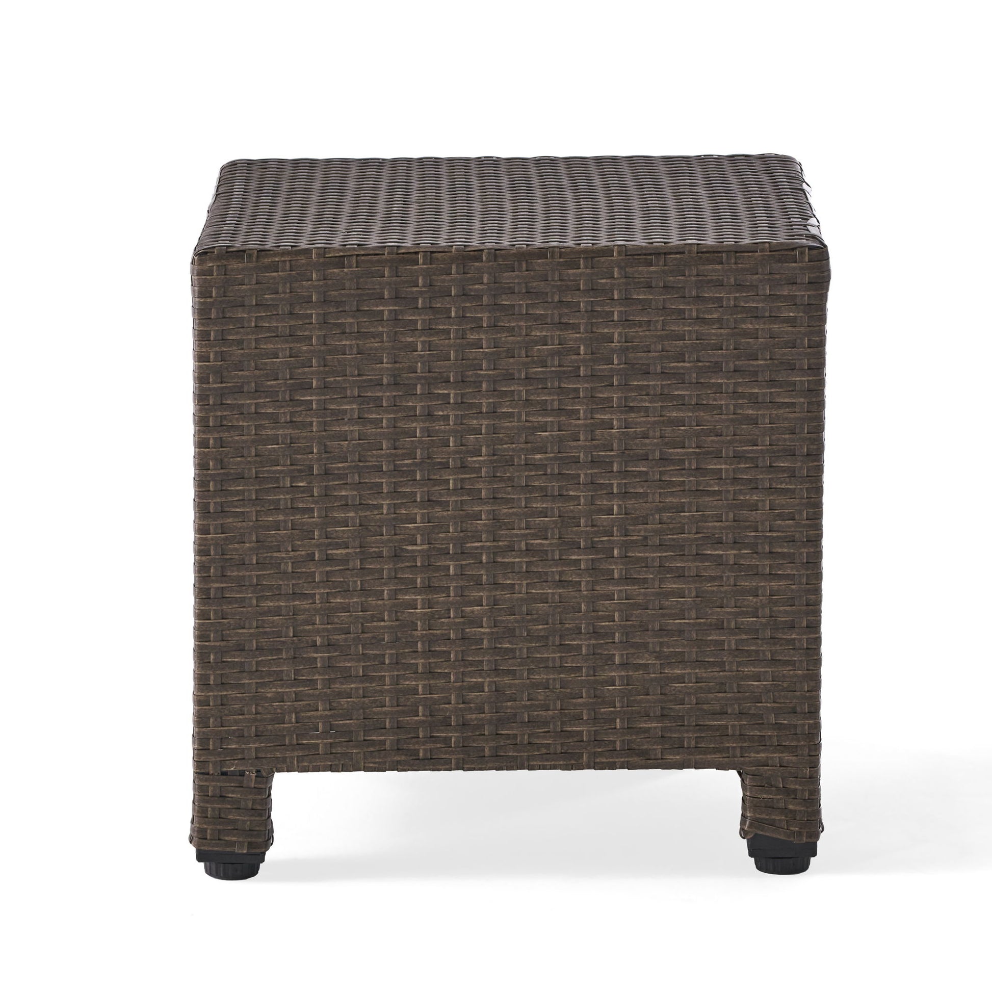 The Puerta Minimalist Style Accent Table features a square design with a flat top and short legs, crafted from brown woven rattan and shown against a white background.