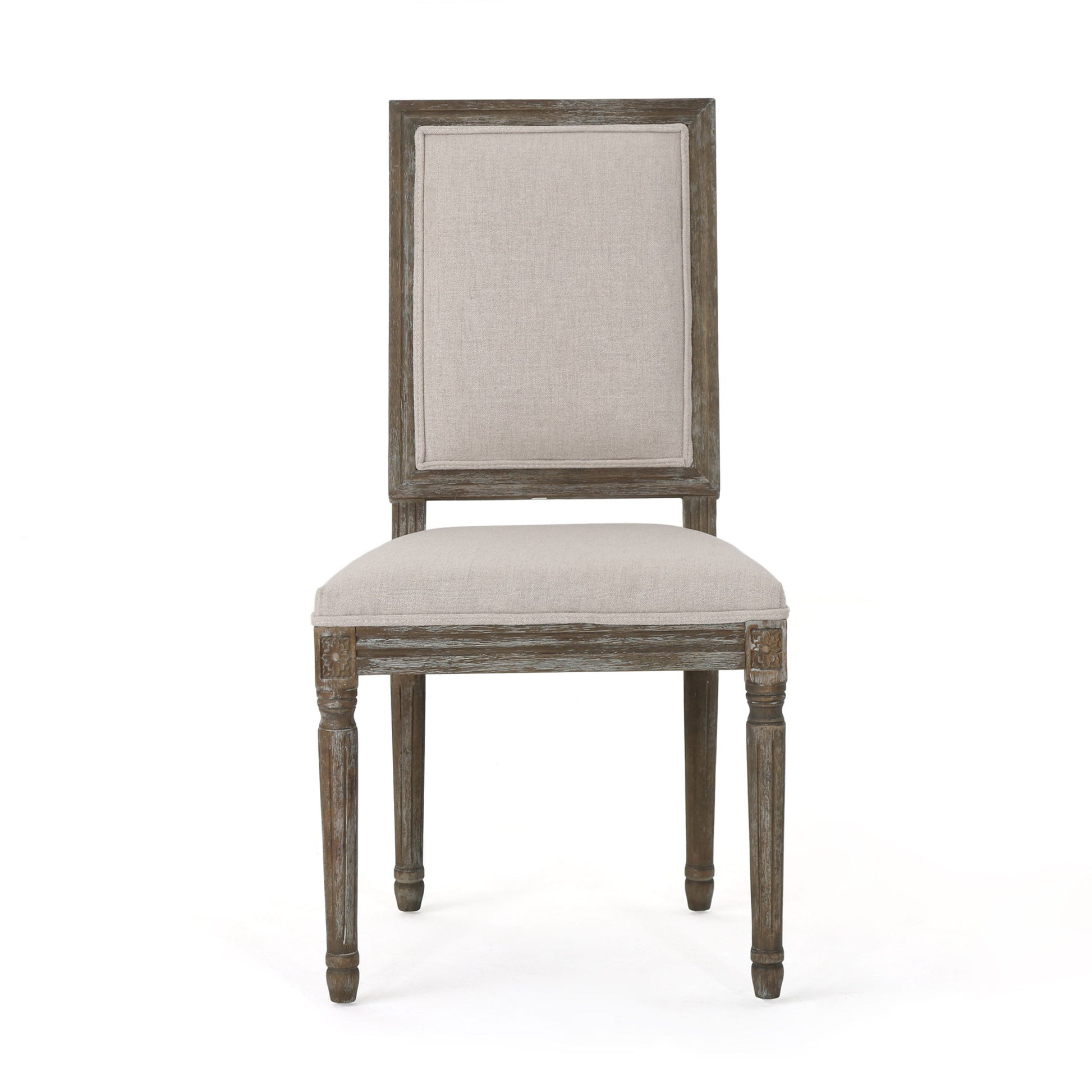 Front view of the Traditional Style Dining Chair Set With Fabric Upholstery featuring a rectangular, padded beige fabric seat and backrest, carved leg detailing, and weathered wood finish.