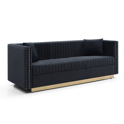 The Contemporary Vertical Channel Tufted Sofa is a modern upholstered black velvet couch for living rooms, featuring vertical tufting, 2 matching pillows, silver nailhead trim on the arms, and a gold base.