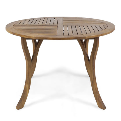 The Hermosa Outdoor Acacia Wood Table features a circular slatted top and curved legs, displayed against a plain white background.