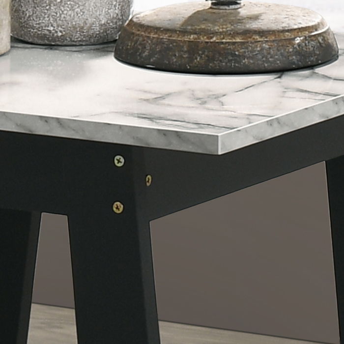A close-up of the Kenzo End Table with a faux marble top finish in black, showing a rustic metal object and part of a gray textured container on its surface.
