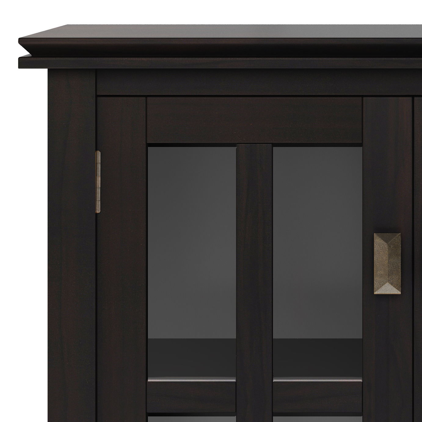 A close-up of the Couch.com Artisan Low Storage Cabinet in hickory brown shows its dark wood construction, glass-paneled door with a geometric metal handle, and an interior storage shelf.