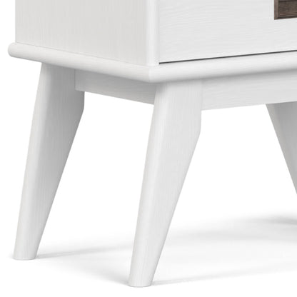 Close-up of the lower portion of the Draper - Mid Century Wide Bookcase And Storage Unit, featuring angled legs and a smooth, modern white finish, standing on a light-colored surface.