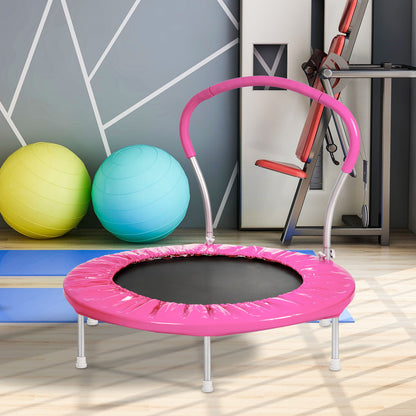 The Kangle Store Trampoline With Handle, in pink and featuring a curved bar, is set in a modern home gym with two large exercise balls, a blue yoga mat, and other gym equipment against a geometric-patterned wall.