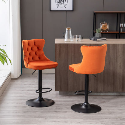 A set of two Swivel Velvet Barstools with adjustable height, tufted backs, and black bases are placed by a wooden kitchen island in a stylish modern room with light wood floors and neutral walls.