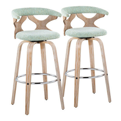 The Gardenia Contemporary Fixed Height Barstool With Swivel (Set of 2) features light wooden legs, round chrome footrests, and upholstered seats and backrests in light green fabric with unique cutout designs.