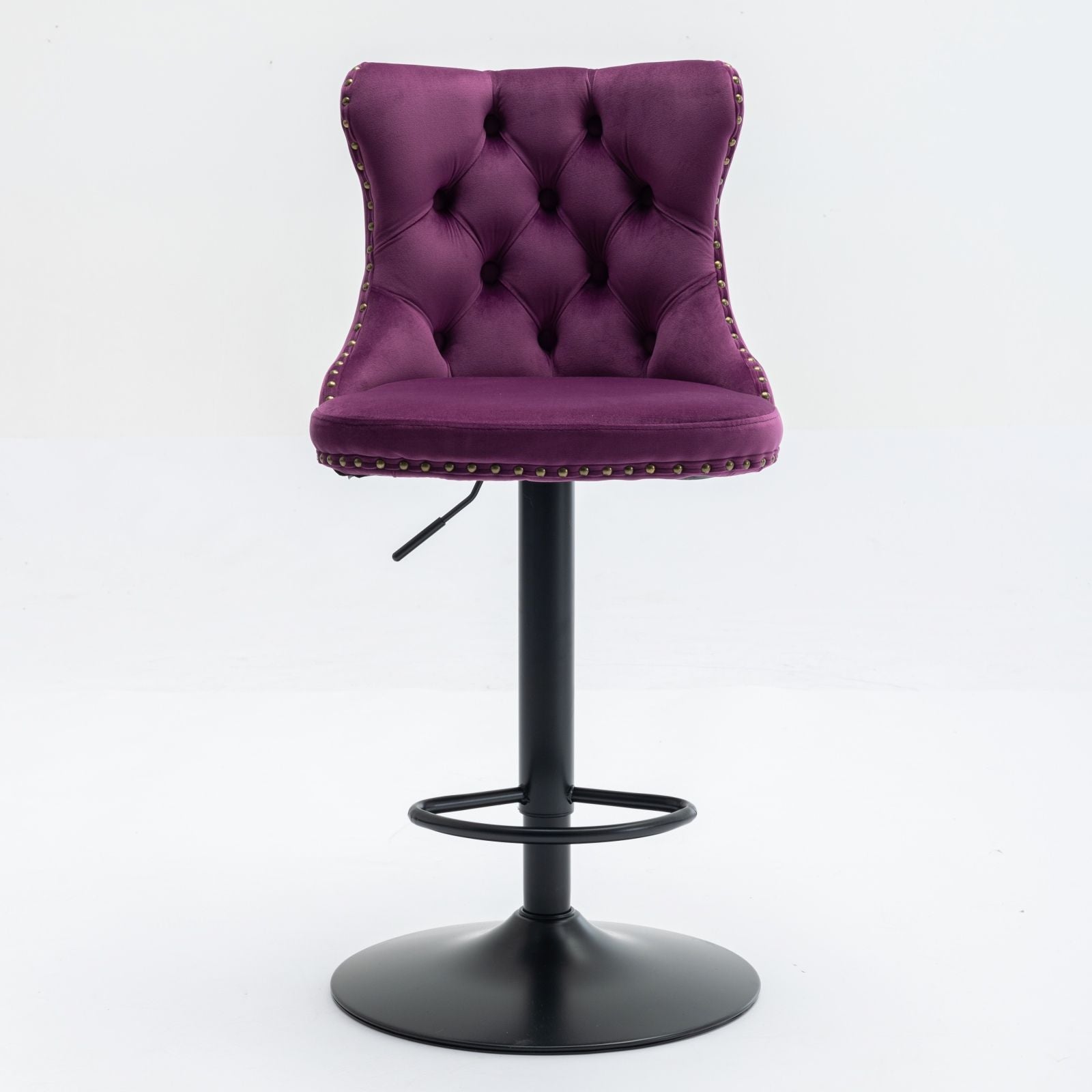 A set of 2 modern purple swivel velvet barstools with tufted backs, silver nailhead trim, and a black adjustable pedestal base with circular footrest, perfect for home pub or kitchen island. Set against a white background.