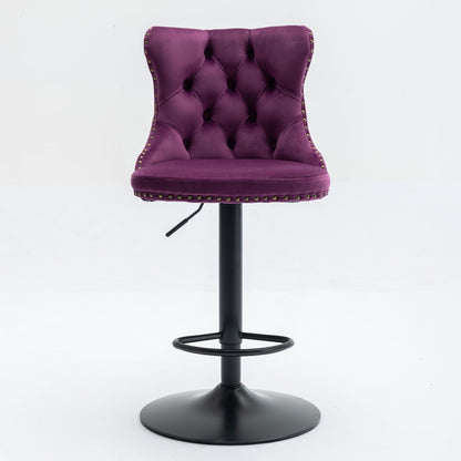 A set of 2 modern purple swivel velvet barstools with tufted backs, silver nailhead trim, and a black adjustable pedestal base with circular footrest, perfect for home pub or kitchen island. Set against a white background.