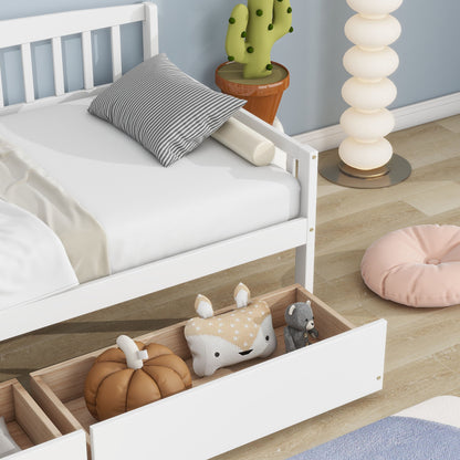 A Pine Wood Daybed with two storage drawers and a sofa bed platform sits by a lamp and cactus. An open drawer under the bed holds plush toys, while a pink floor cushion rests on the wooden floor.