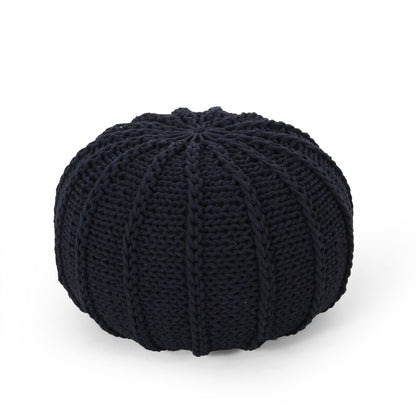 The Bordeaux Knitted Cotton Round Pouf Ottoman and Floor Cushion features a black, ribbed design with thick visible yarn, showcased on a plain white background.