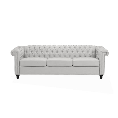 The Chesterfield Style 3 Seater Sofa With Deep Button Tufting features a light gray finish, tufted backrest, rolled arms, and dark wooden legs, shown here against a white background.