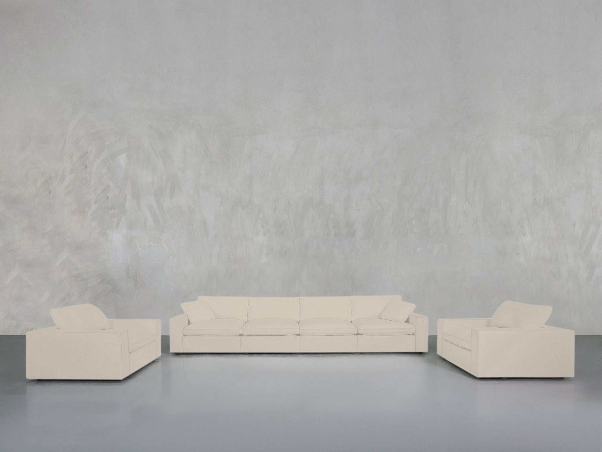The 4-1-1 Sofa & Armchair Set is displayed in a minimalist living room with white, modern pieces arranged against a light gray textured wall and smooth gray floor for a clean, simple look.