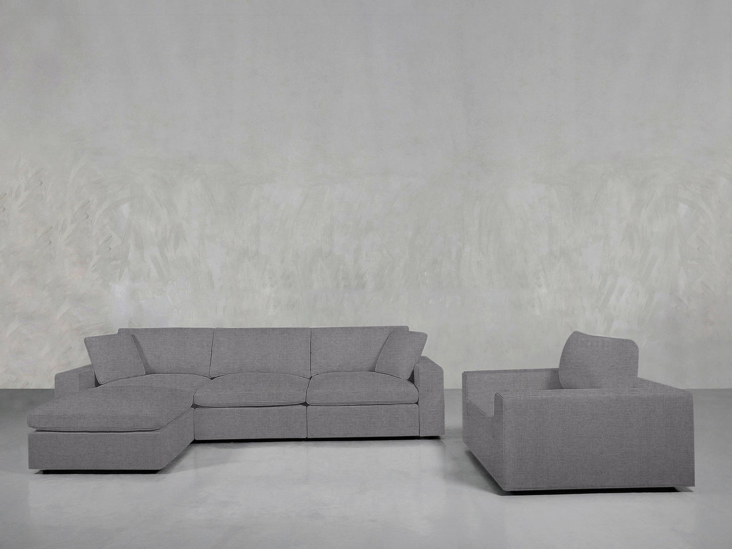 The 4-1 Sectional & Armchair Set features a light gray sectional sofa with a left-facing chaise and a matching armchair, arranged against light gray textured walls and flooring for a modern living room look.