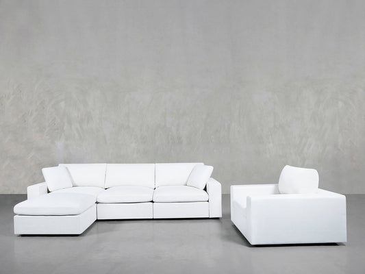 A modern minimalist living room showcasing the 4-1 Sectional & Armchair Set in white, with a left-facing chaise sectional and matching armchair on a gray floor against a light gray textured wall.