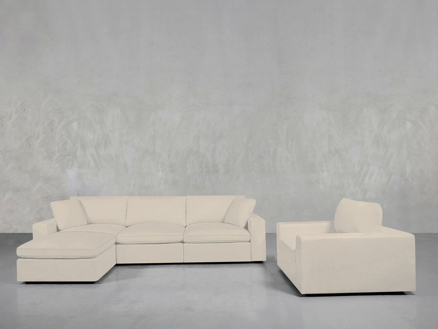 The 4-1 Sectional & Armchair Set features a modern light beige sectional with a left chaise and a matching armchair, arranged against a light gray textured wall and floor.