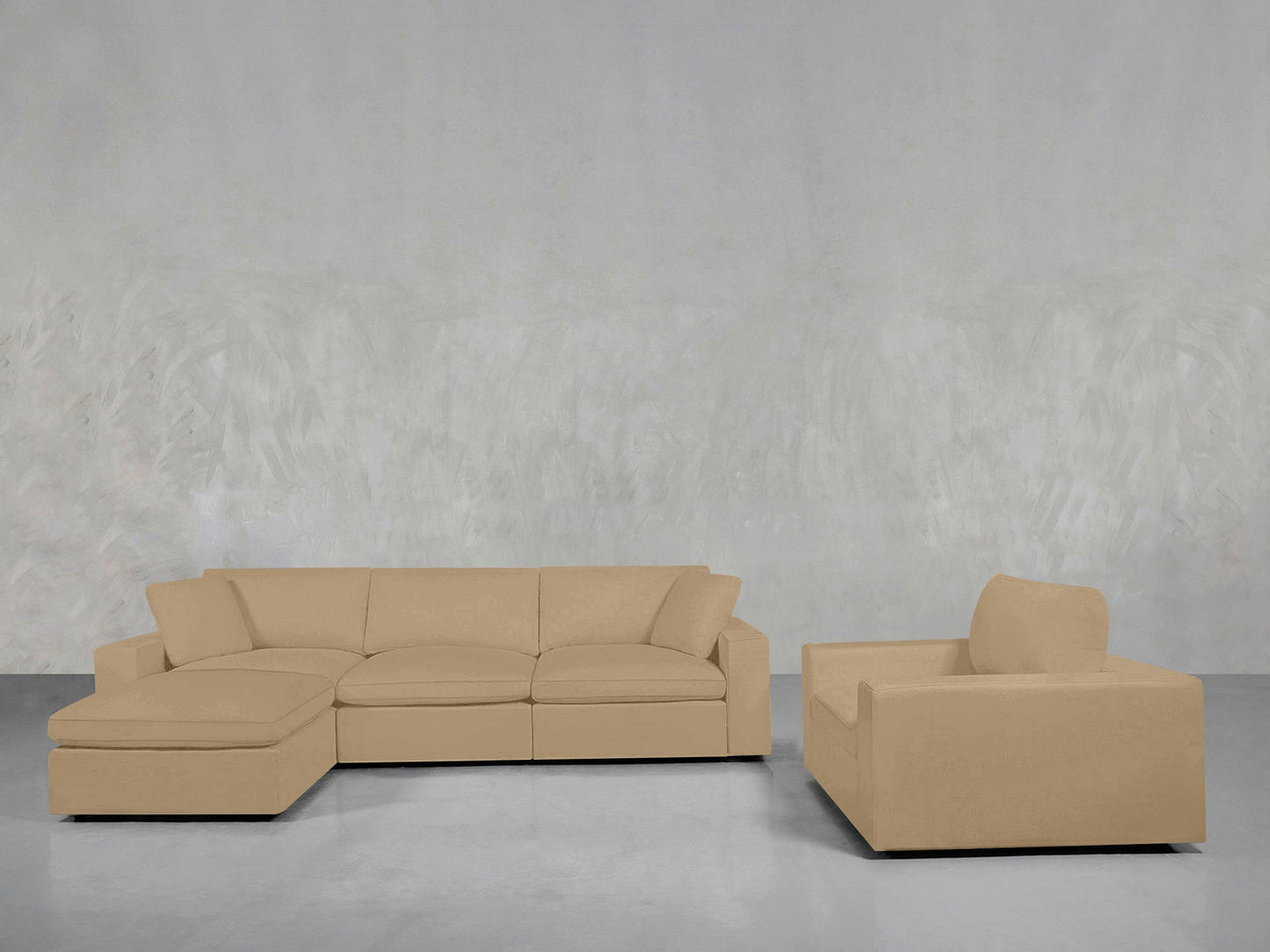 The 4-1 Sectional & Armchair Set in beige features a left chaise, paired with a matching armchair, arranged against a light gray textured wall and smooth gray floor.
