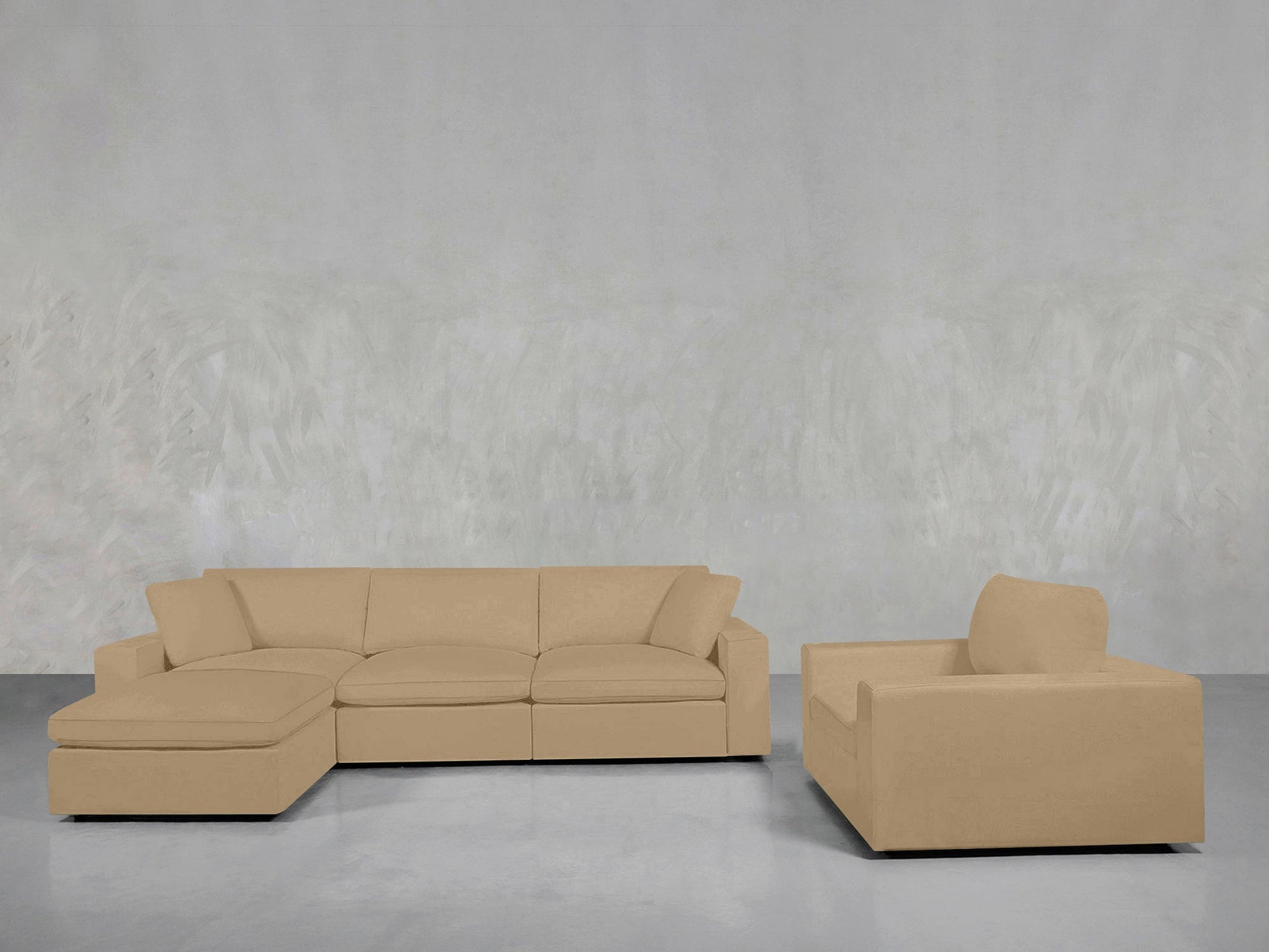 The 4-1 Sectional & Armchair Set in beige features a left chaise, paired with a matching armchair, arranged against a light gray textured wall and smooth gray floor.