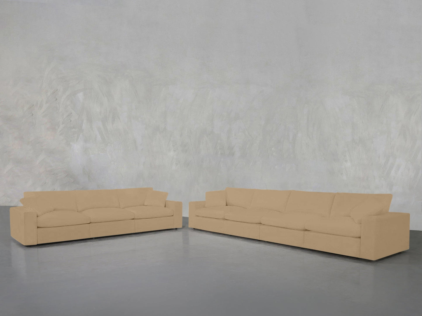 The 4-3 Sofa Set in beige, featuring plush cushions, is arranged in an L-shape against a textured light gray wall and a smooth gray floor.