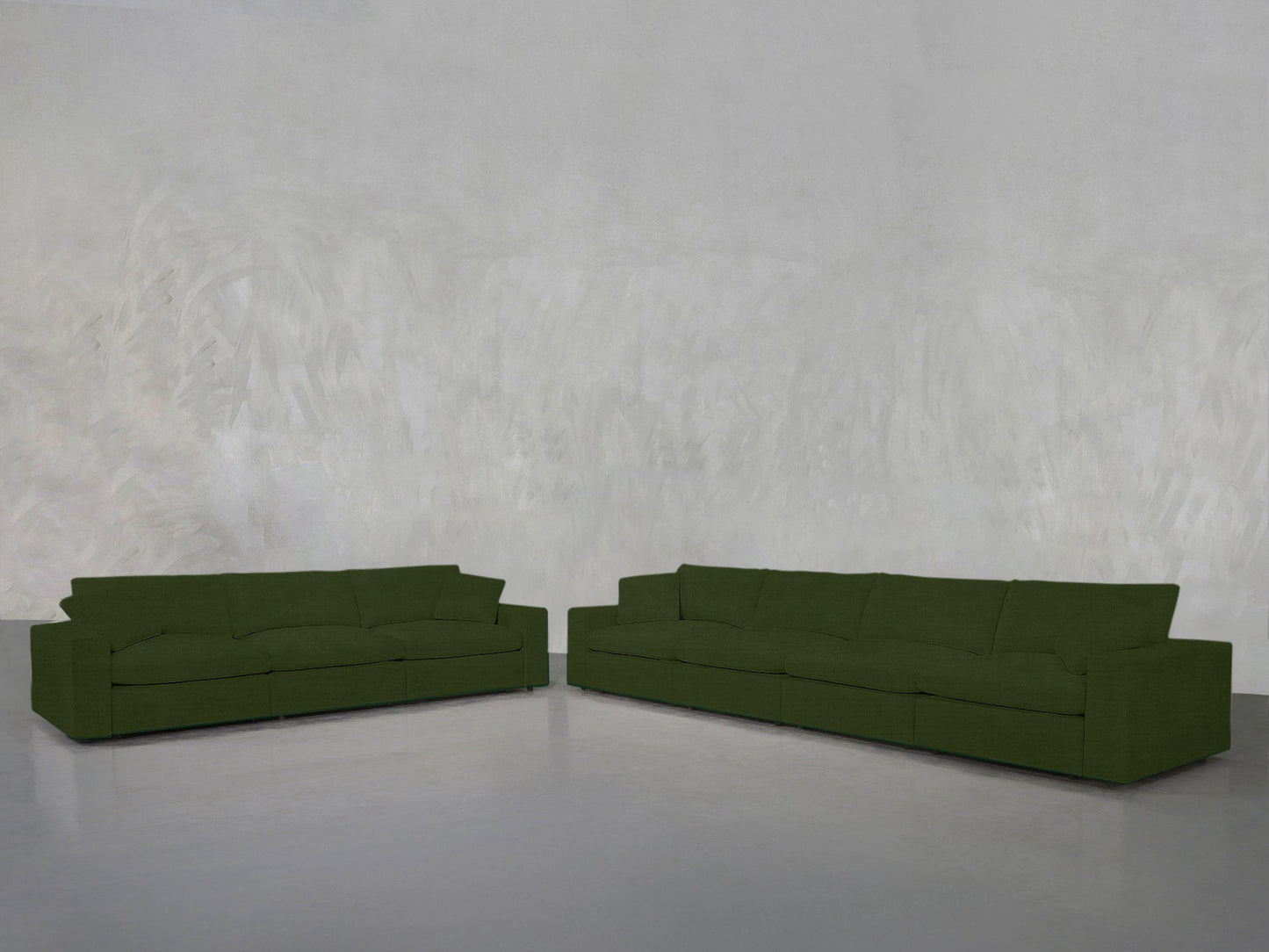 Two 4-3 Sofa Sets with clean lines are arranged in an L-shape on a gray floor against a textured light gray wall in a minimal, modern room.
