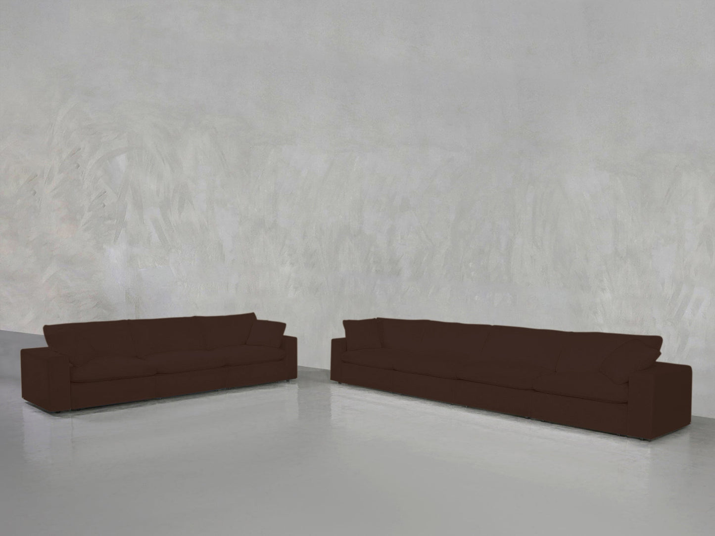 The 4-3 Sofa Set, featuring two modern brown sofas, is arranged in a minimalist room with light gray textured walls, a shiny reflective floor, and an open, sparsely decorated space.