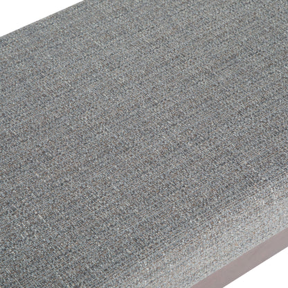 Close-up of the Chanelle - Mid-Century Ottoman Bench, featuring textured, woven gray fabric with subtle color variations that highlight the detailed pattern of its upholstery.