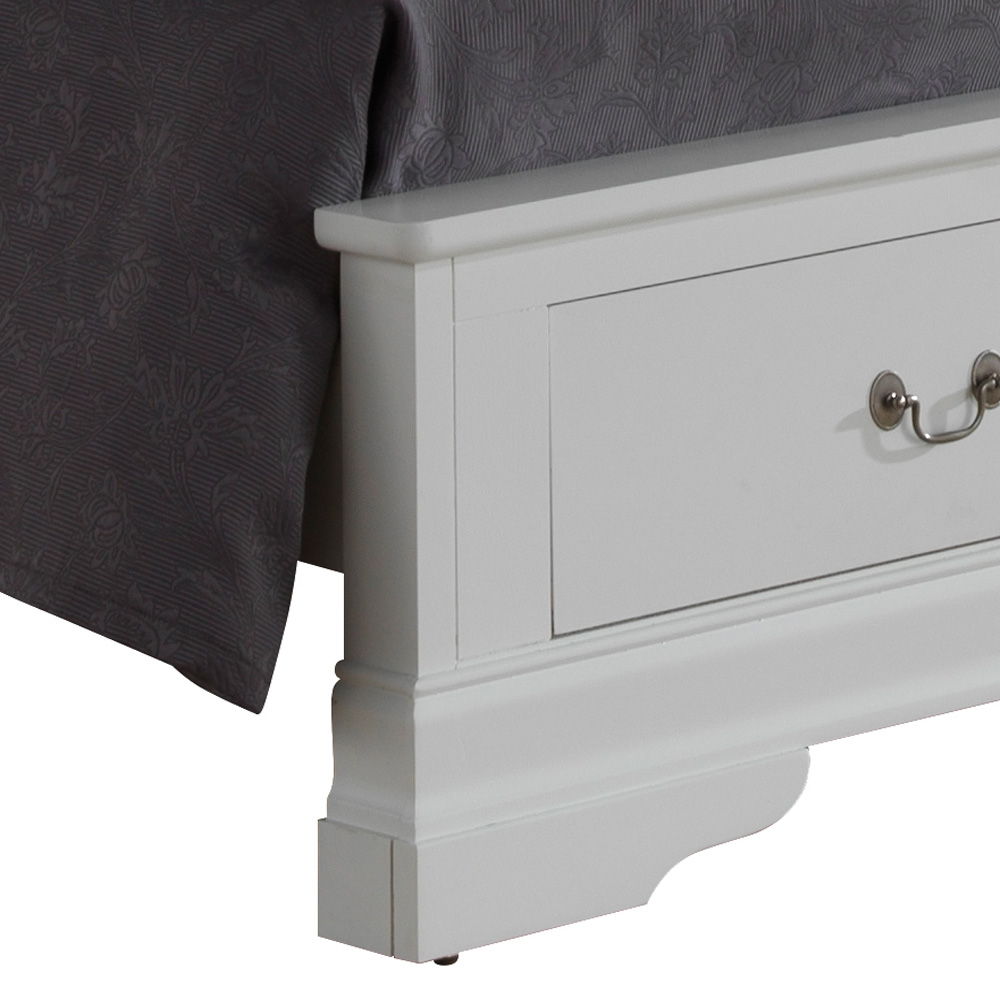 Close-up of the lower corner of the Louis Phillipe - Storage Bed, a white wooden frame with a built-in drawer and metal handle, placed beside a bedspread with a dark gray floral pattern.
