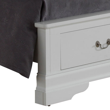 Close-up of the lower corner of the Louis Phillipe - Storage Bed, a white wooden frame with a built-in drawer and metal handle, placed beside a bedspread with a dark gray floral pattern.