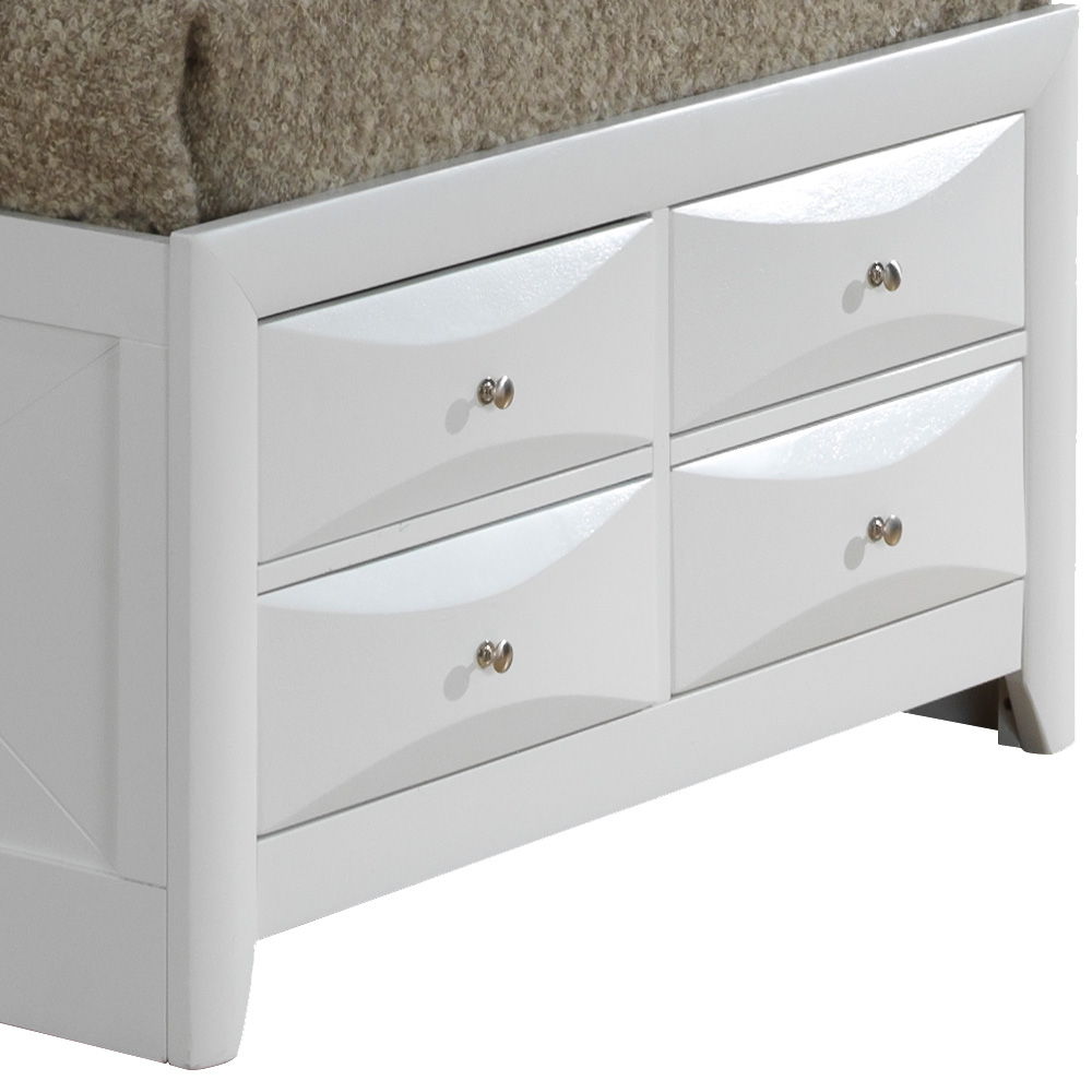 A close-up of the Marilla Storage Bed With Bookcase Headboard, featuring a white wooden frame with four storage drawers with round silver knobs and topped with a beige textured blanket.