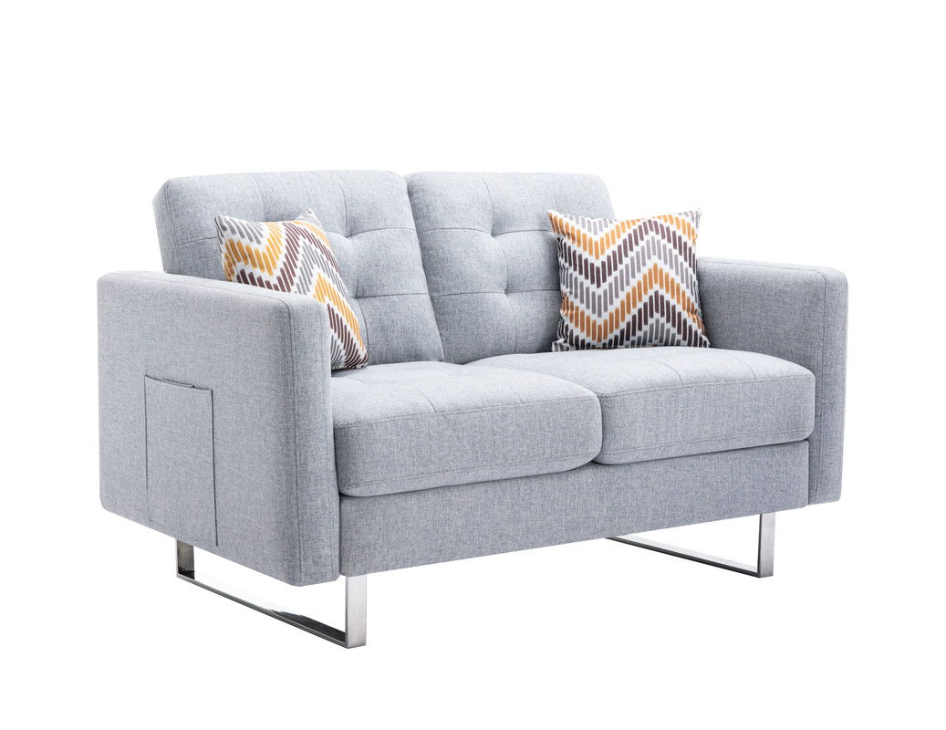 The Victoria Linen Fabric Loveseat features tufted cushions, sleek metal legs, side armrest pockets, and two zigzag-patterned pillows in yellow, gray, and white.