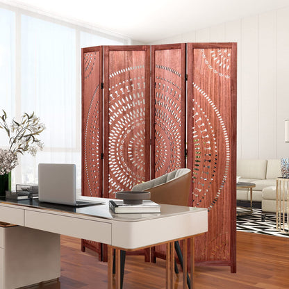 A modern home office with a white desk, laptop, and brown chair is separated from the living room by a Panel Solid Wood Folding Room Divider featuring intricate circular cut-out patterns.