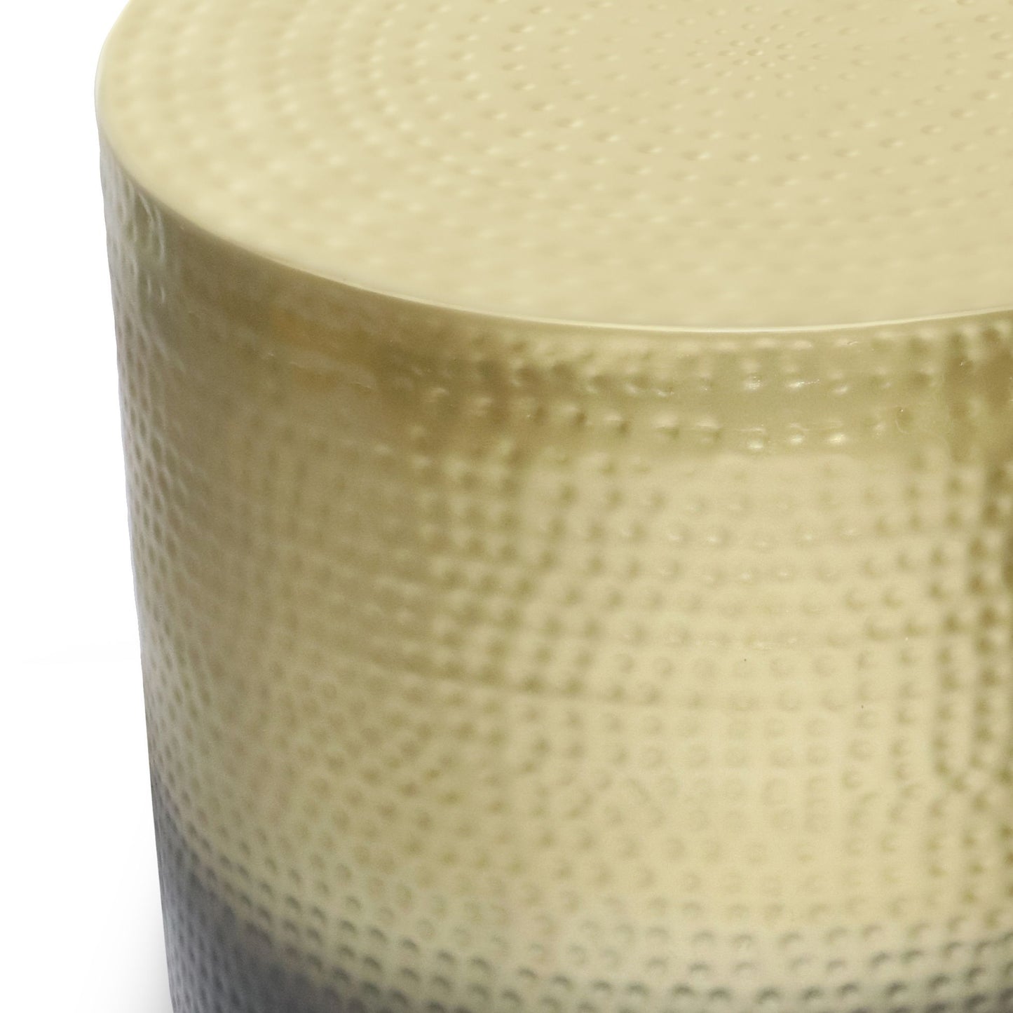 Close-up view of the Nova - Handcrafted Metal Side Table, featuring a cylindrical form with a dotted texture and gradient color from beige at the rounded top to darker shades below.