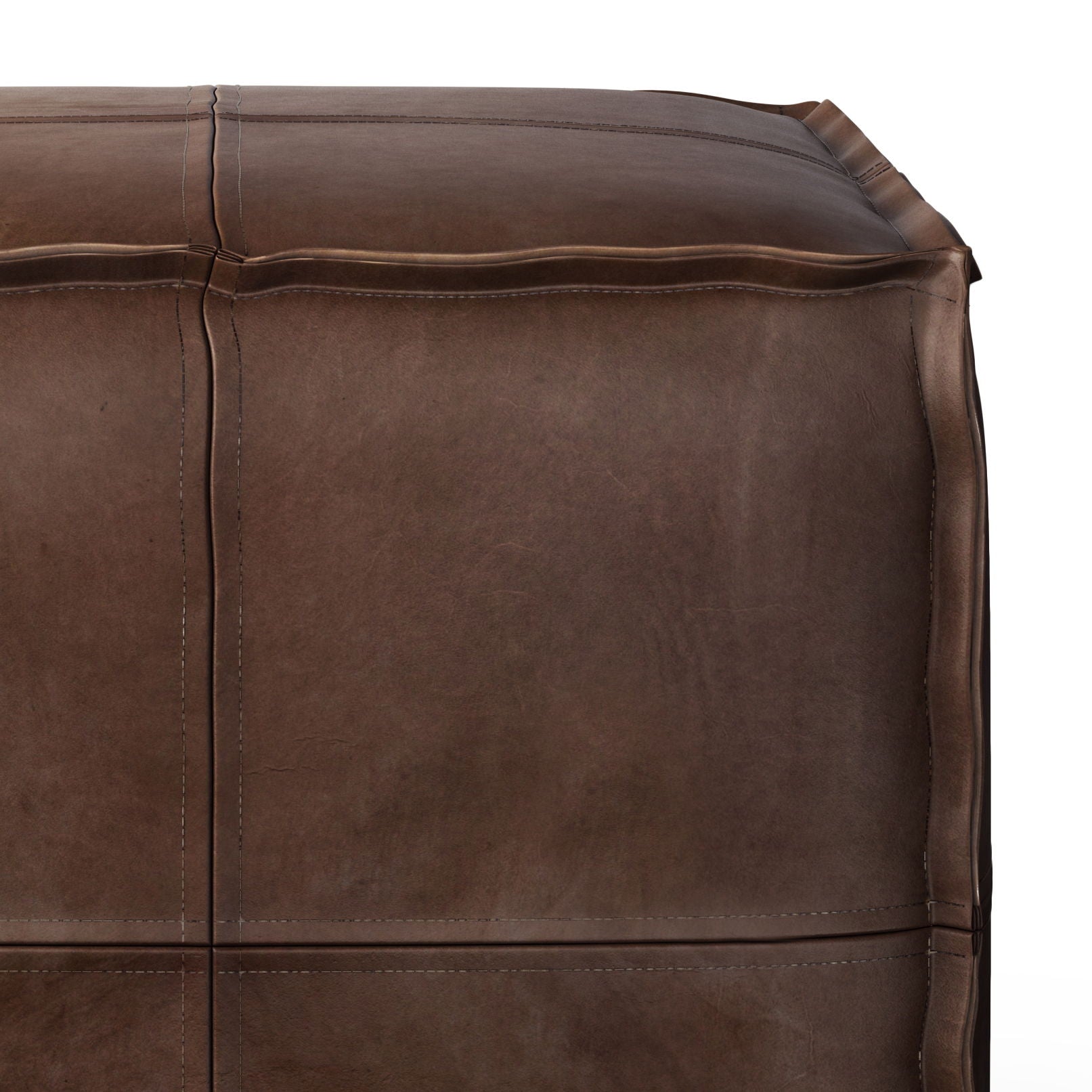 Close-up of the Brody - Versatile Square Pouf in brown leather, highlighting stitched seams and a smooth, slightly worn texture.