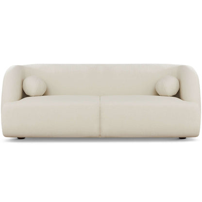 The Anna - French Boucle Sofa is a modern, minimalist cream-colored sofa with rounded edges and two matching cylindrical pillows, shown from the front against a plain white background.