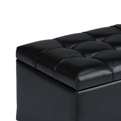 Close-up of the Sienna Upholstered Storage Ottoman Bench in black leather with tufted stitching on the cushioned top, set against a white background.