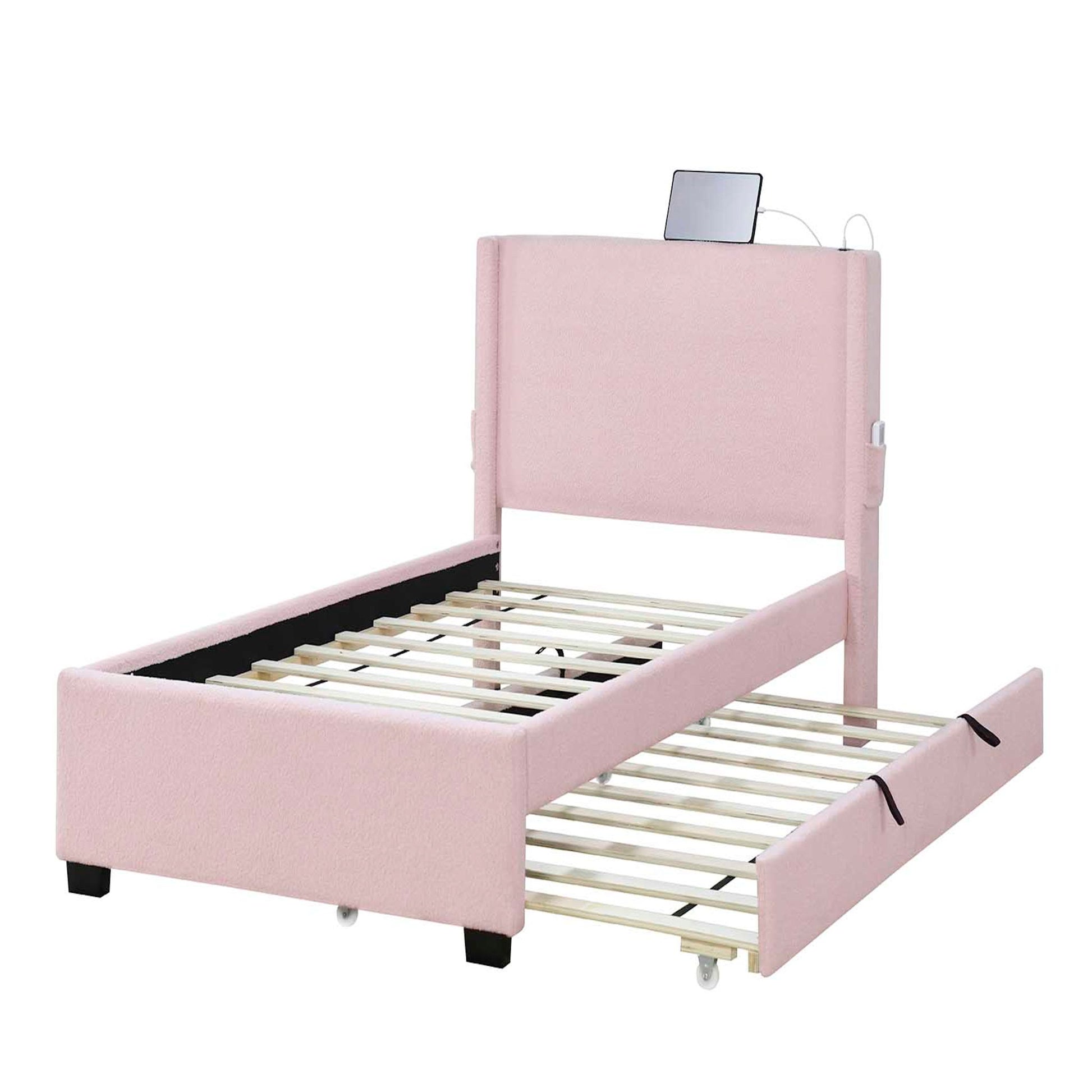 A baby pink twin size upholstered bed frame with trundle, teddy fabric, USB functionality, and a headboard pocket for small item storage.