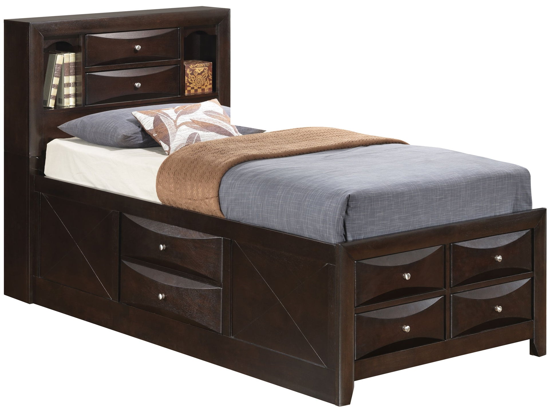 The Marilla Storage Bed With Bookcase Headboard is a dark wood twin bed featuring built-in drawers on the side and footboard, plus a headboard with shelves holding books and decor. It's shown made up with gray and brown bedding and a white pillow.