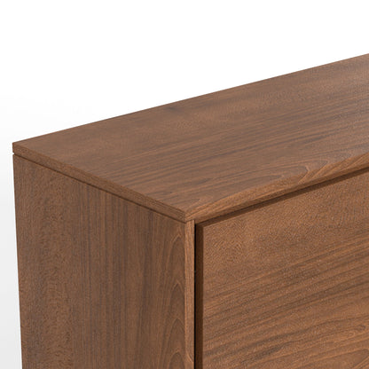 A close-up of the Lowry Handcrafted Sideboard Buffet corner highlights its smooth, natural wood finish and visible grain patterns, set against a white background.