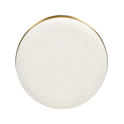 The Nebula Backless Round Upholstered Counter Stool in Burl and Ivory White features a textured, smooth-edged round seat with a thin gold rim, shown from above on a white background.