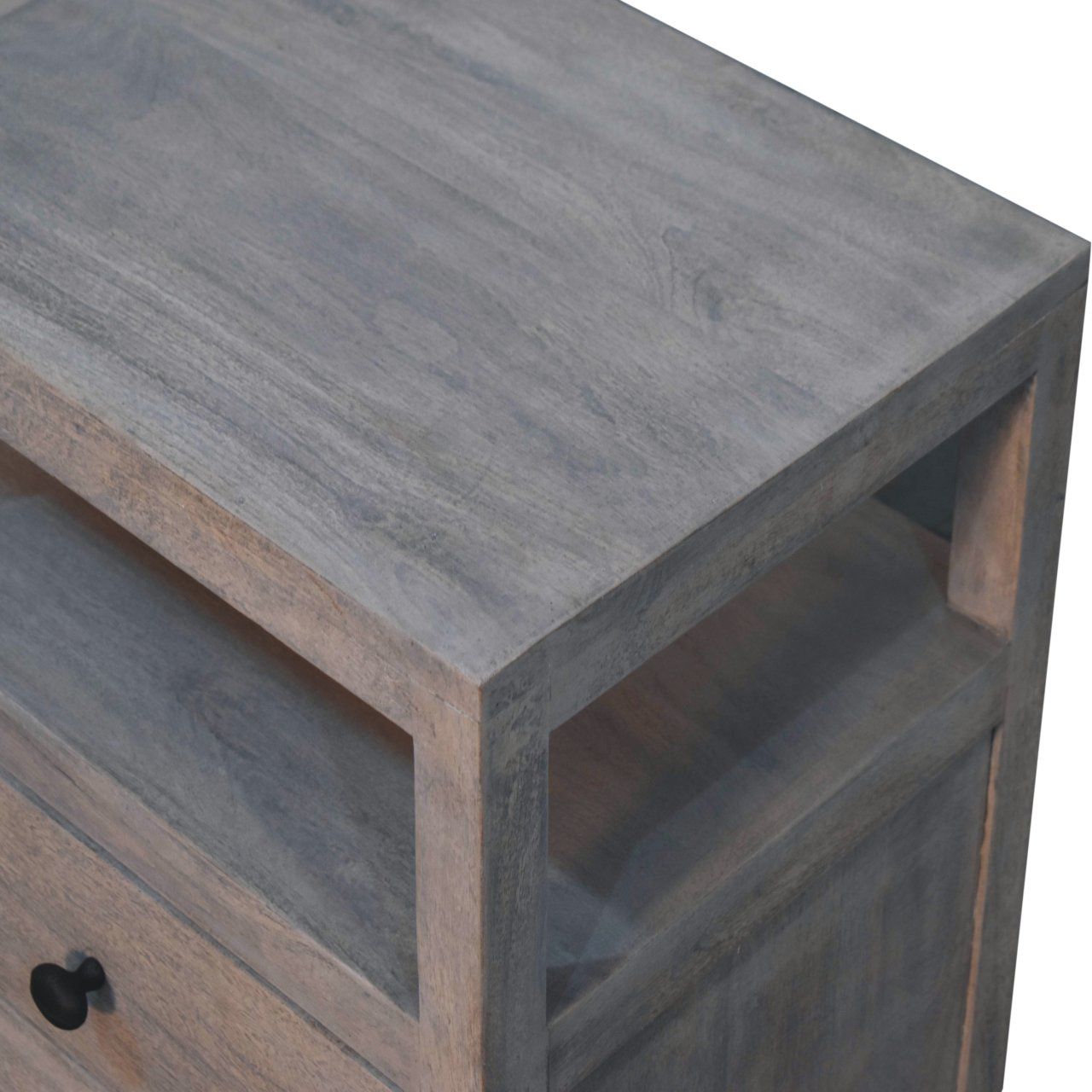 A close-up of the Acid - 2 Drawer Open Bedside Table in Gray Ash, showing its wooden finish, an open shelf, and part of a drawer with a round black knob.