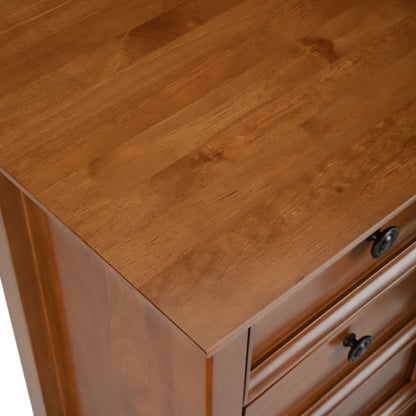 A close-up of the Amherst - Handcrafted Medium Storage Cabinet highlights its smooth, polished wood surface, visible grain, and partial drawers featuring round black metal knobs.
