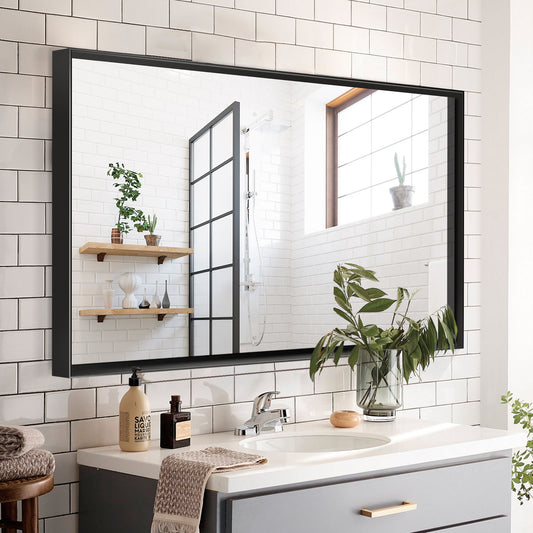 A modern bathroom features a Rectangular Bathroom Mirror Square Angle Metal Frame Wall Mounted above a sink with a silver faucet, white subway tiles, a potted plant on the counter, and wooden shelves with plants reflected in the mirror.