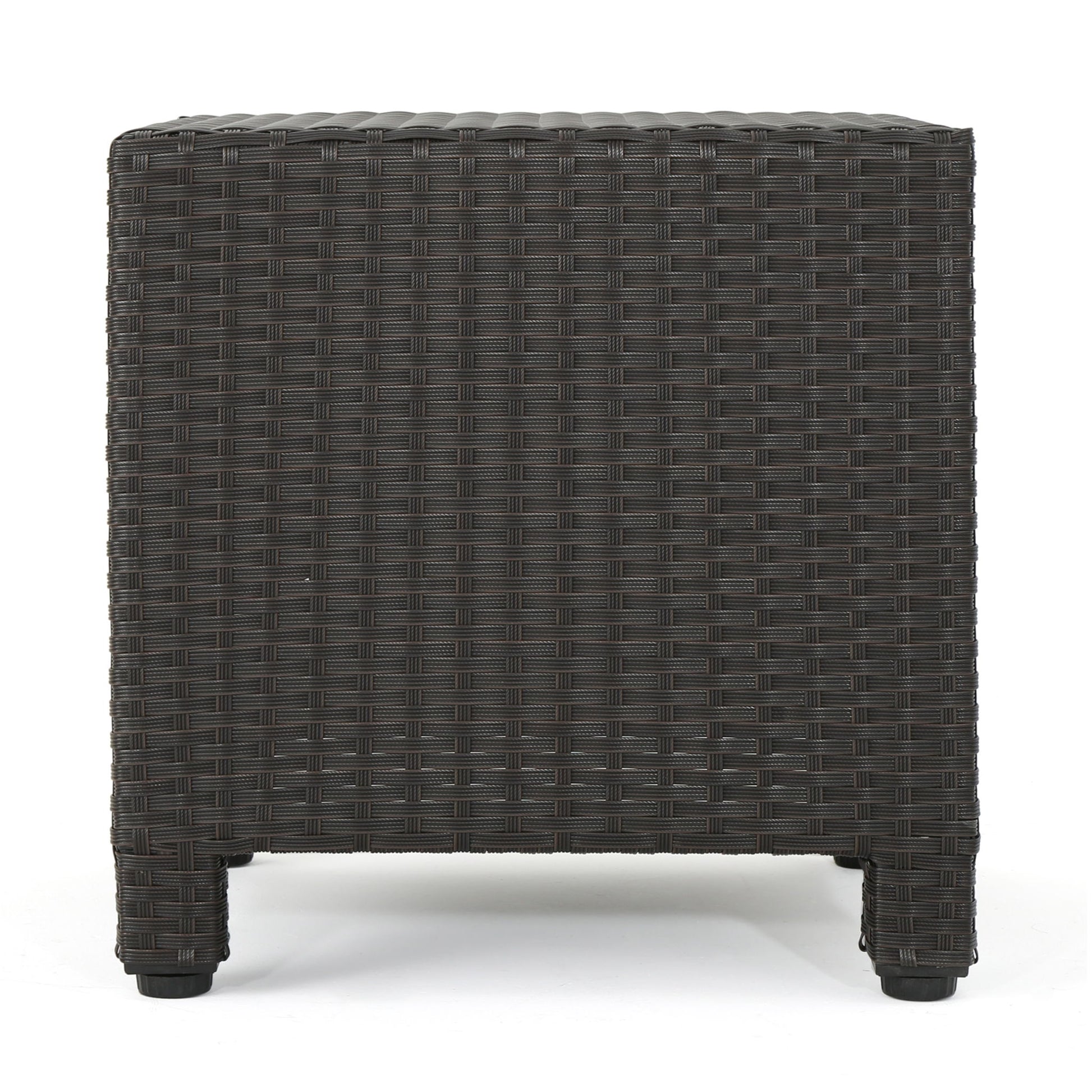 The Puerta - Minimalist Style Accent Table is a dark brown, square wicker outdoor side table with four short legs, shown from the side against a white background.