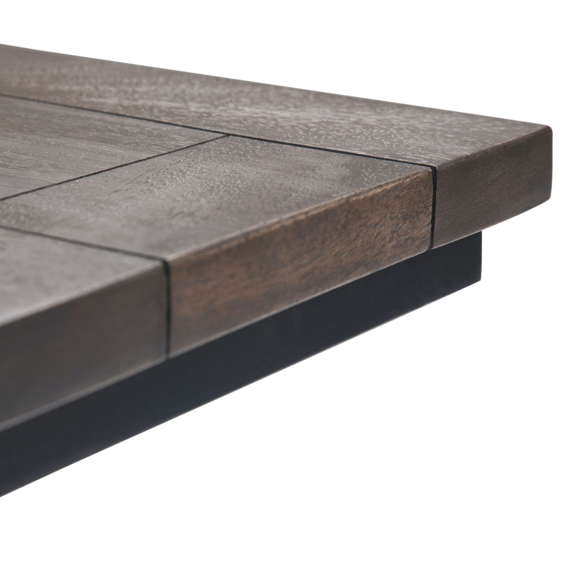 Close-up of the Skyler - C Side Handcrafted Table’s corner, featuring a dark brown wood grain top with straight edges, supported by a sleek black base.
