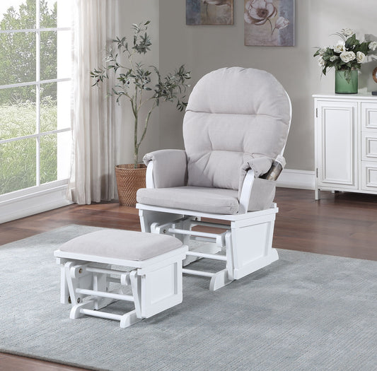 The Madison - Glider & Ottoman - White Base in gray sits on a light blue rug in a bright living room with wood floors, large windows, a potted plant, white sideboard, and floral wall art. Natural light fills the space.