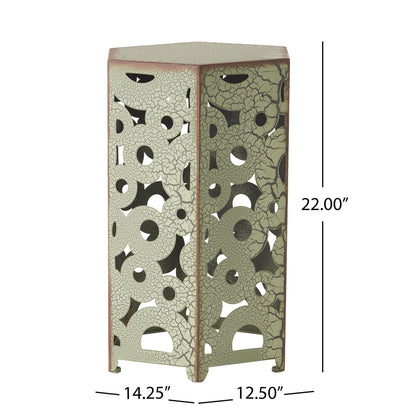 The Selva - Accent Table Set includes a pentagonal metal table with a cracked, distressed green finish and circular/geometric cutouts. It measures 22"H x 14.25"W x 12.5"D.