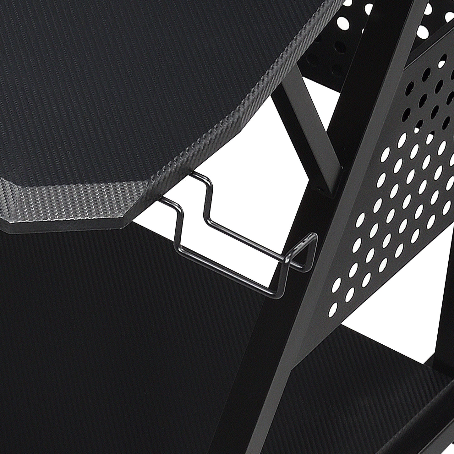 Close-up of the Willow - Versatile Music Desk, showcasing its black carbon fiber textured surface, built-in metal headphone holder, and perforated side panel for ventilation or design.